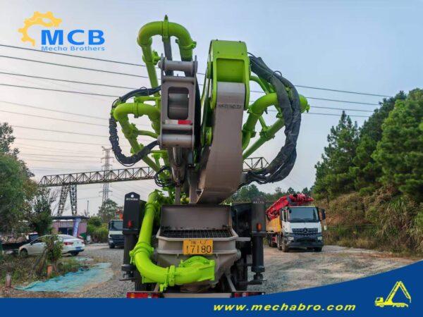 2022 Zoomlion 61.2m SITRAK pump truck — rear view with hopper and folded boom 2022 Zoomlion 61.2m concrete pump truck on SITRAK C7H chassis, rear view with hopper and folded boom