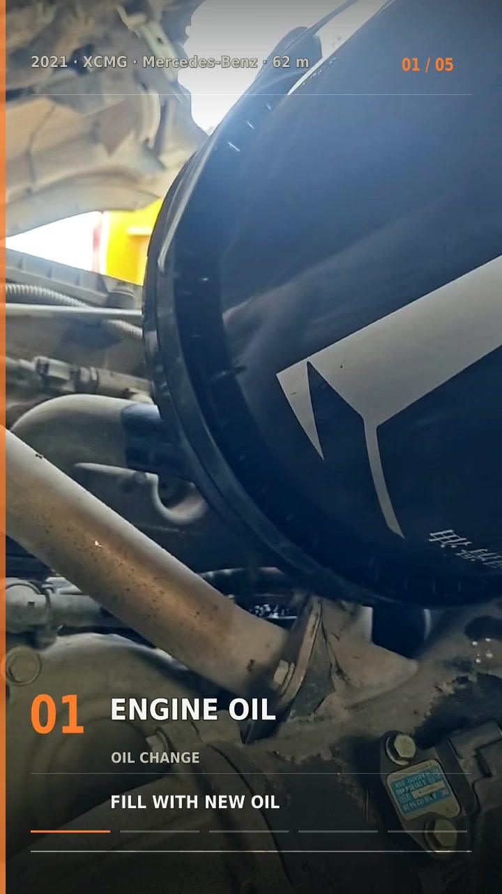 Original Mechabro field photo from the 2021 XCMG pump truck 62m pre-shipment service video, showing engine oil refill