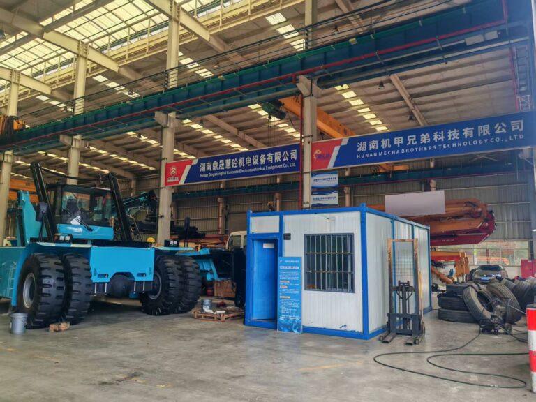 Original Mechabro field photo of the used concrete pump truck refurbishment workshop and company sign in Changsha
