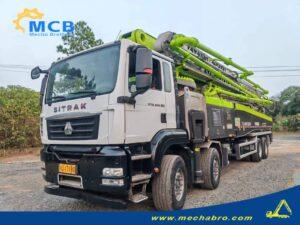 Original Mechabro field photo of a 2022 Zoomlion concrete pump truck 62m on a SITRAK four-axle chassis