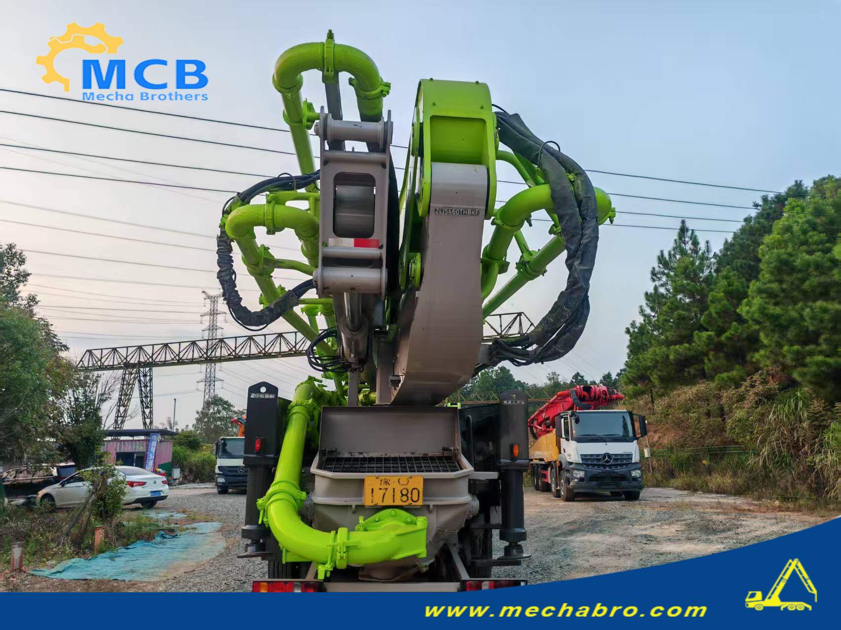 Original Mechabro field photo for a concrete pump truck price review, showing rear pipework, hopper and folded Zoomlion boom